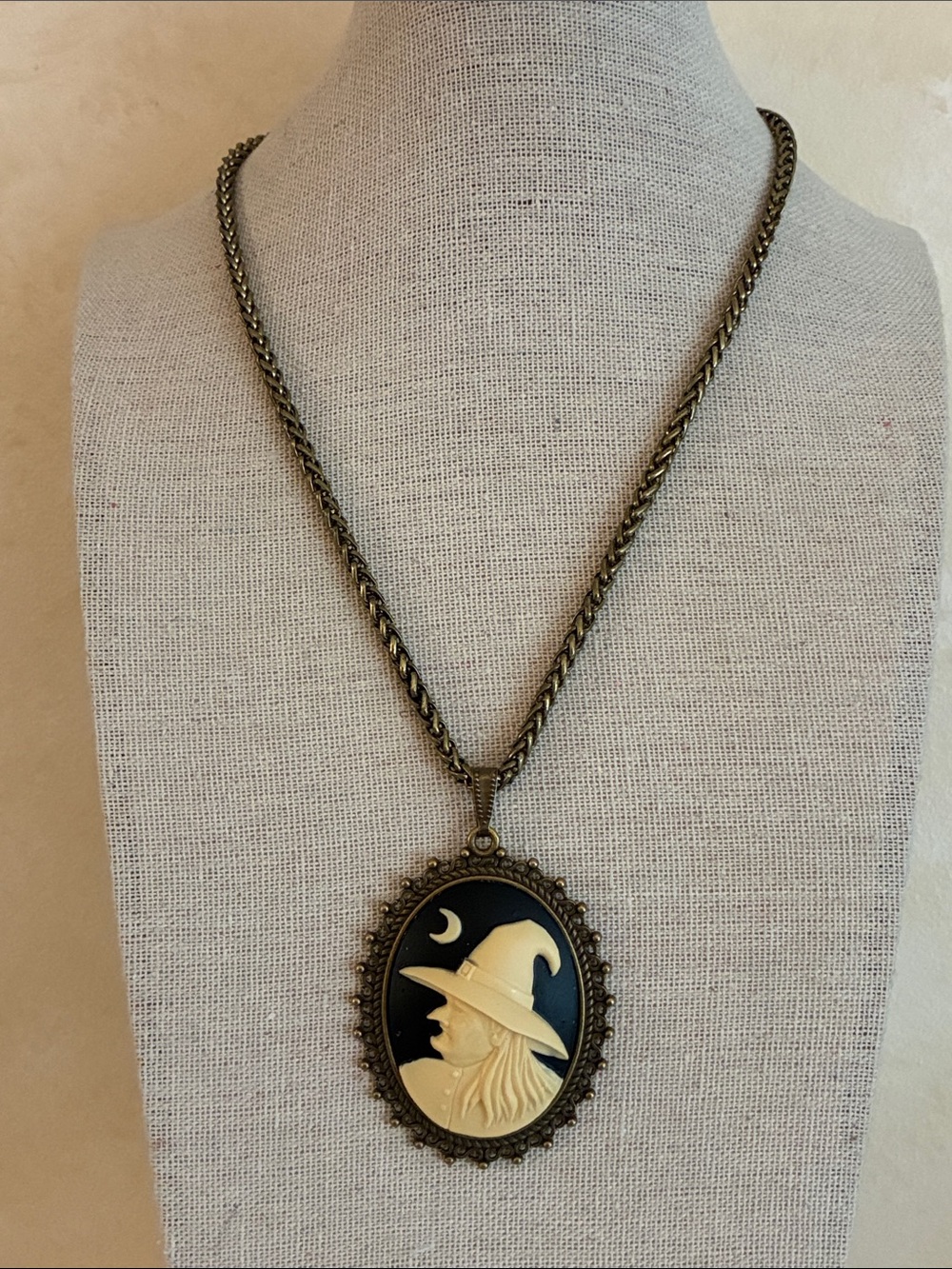 Oval witch black and ivory pendant necklace in brass tone setting